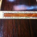 Brazilian rosewood with a figured she oak insert sounded with figured mother of pearl and mitered throughout